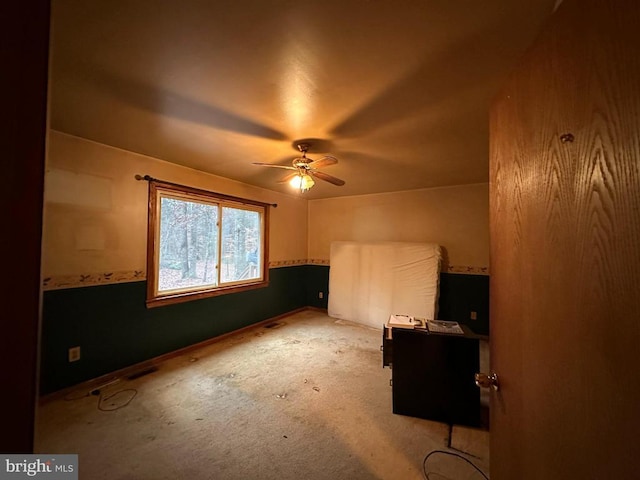 interior space with ceiling fan