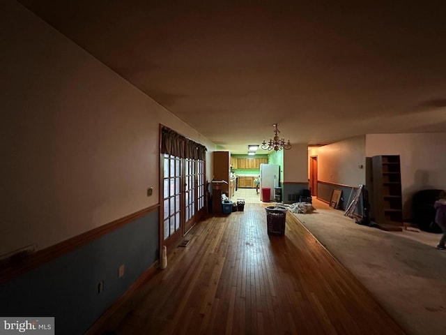 dining room with hardwood / wood-style floors and a notable chandelier