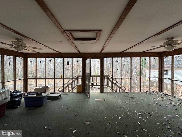 unfurnished sunroom with ceiling fan