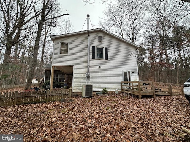 back of house with a deck and central air condition unit