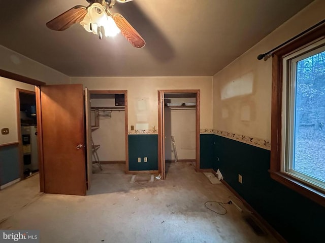 unfurnished bedroom featuring water heater and ceiling fan