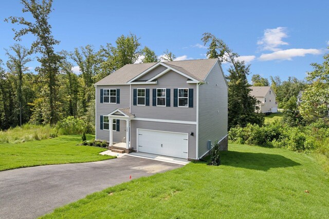 view of front of home featuring a garage and a front lawn