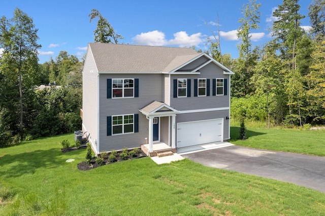 view of front of property with a garage, central AC unit, and a front yard