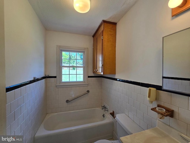 full bathroom featuring tile walls, a wainscoted wall, a garden tub, and toilet