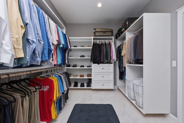 walk in closet with marble finish floor