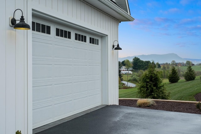 garage featuring driveway and a mountain view