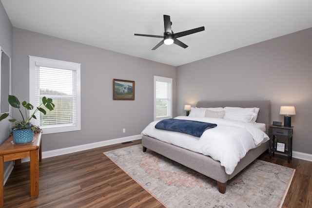 bedroom featuring dark wood-style floors, baseboards, and ceiling fan