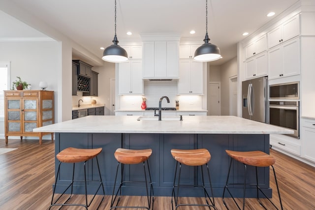 kitchen featuring recessed lighting, backsplash, stainless steel appliances, and dark wood-type flooring