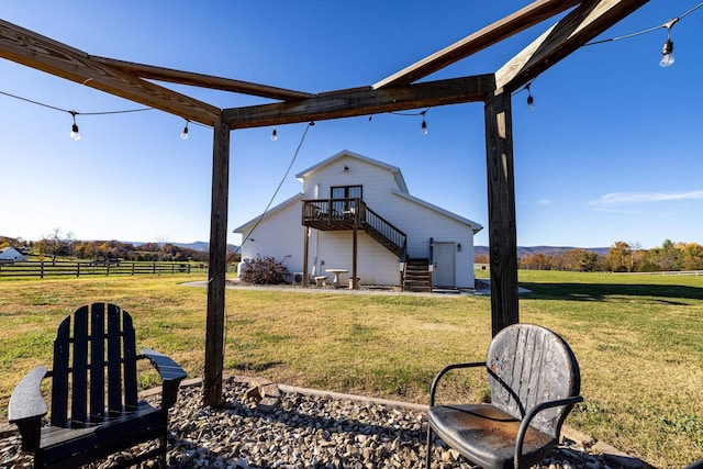 view of yard with a wooden deck and a rural view