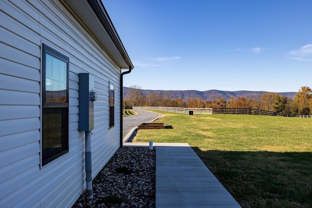 view of yard with a mountain view and a rural view