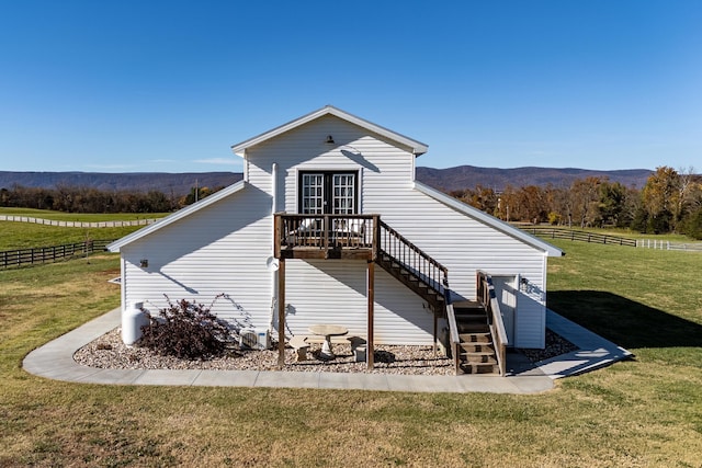 exterior space featuring a yard and a deck with mountain view