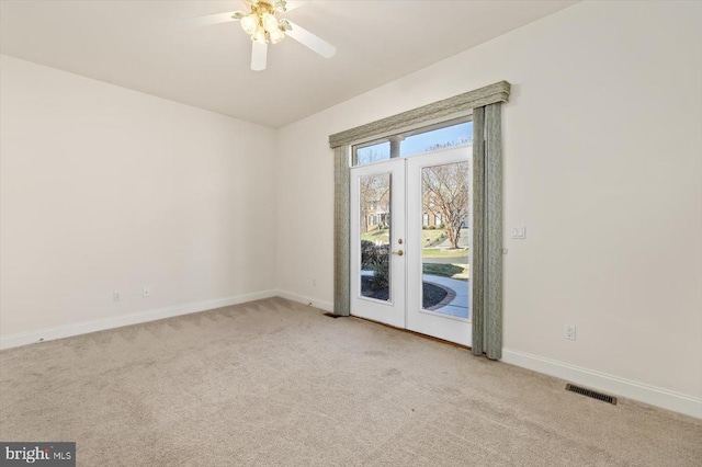 spare room featuring french doors, baseboards, a ceiling fan, and carpet flooring