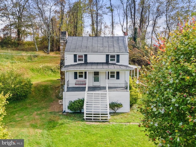 view of outdoor structure with a lawn and covered porch