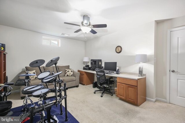 carpeted office space with ceiling fan