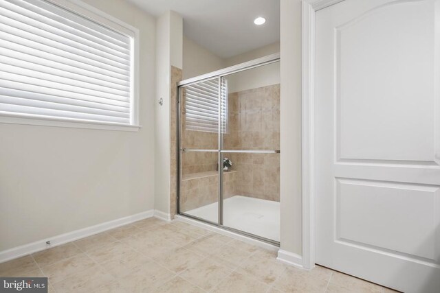 bathroom with tile patterned floors and walk in shower