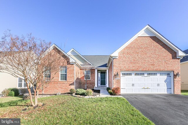 view of front of house with a front lawn and a garage