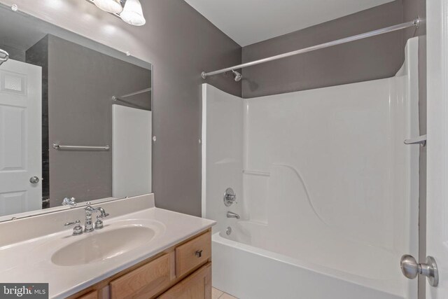 bathroom with vanity and bathtub / shower combination