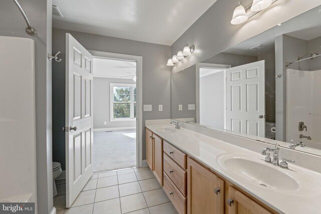 full bathroom featuring vanity, tub / shower combination, tile patterned floors, and toilet