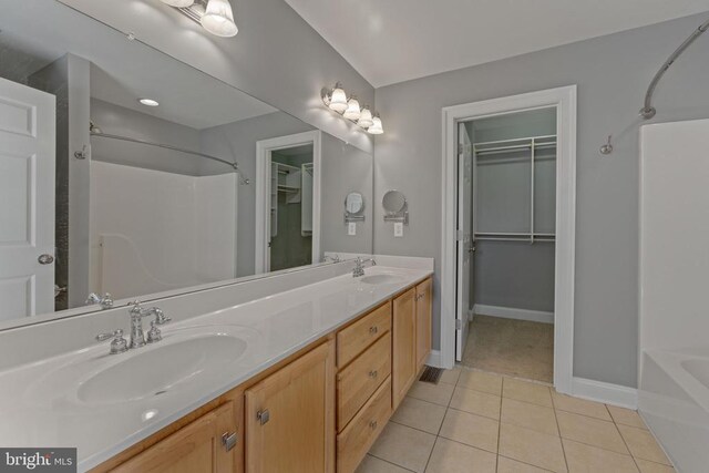 bathroom with tile patterned floors, shower with separate bathtub, and vanity