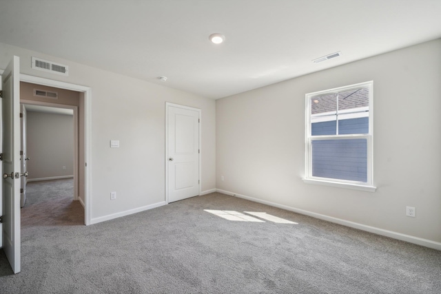 unfurnished bedroom featuring carpet flooring, baseboards, and visible vents