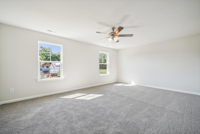 empty room featuring visible vents, baseboards, and carpet