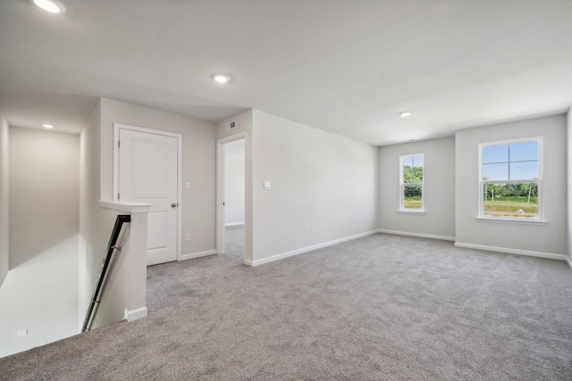 carpeted empty room featuring visible vents, recessed lighting, and baseboards