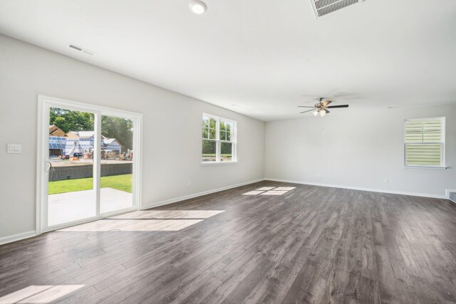 spare room featuring dark wood-type flooring, baseboards, visible vents, and ceiling fan