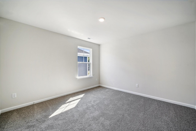 unfurnished room featuring baseboards, carpet floors, and visible vents