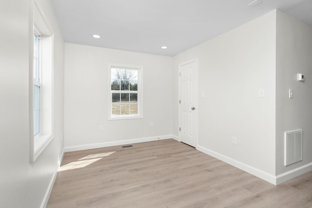 spare room with visible vents, recessed lighting, light wood-type flooring, and baseboards