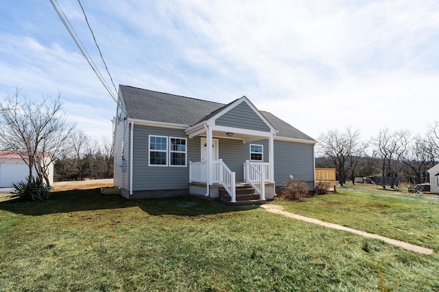 bungalow-style house featuring a front yard and a shingled roof