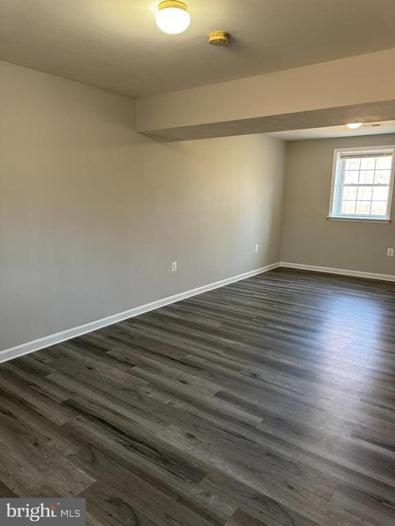 unfurnished room featuring dark wood-type flooring