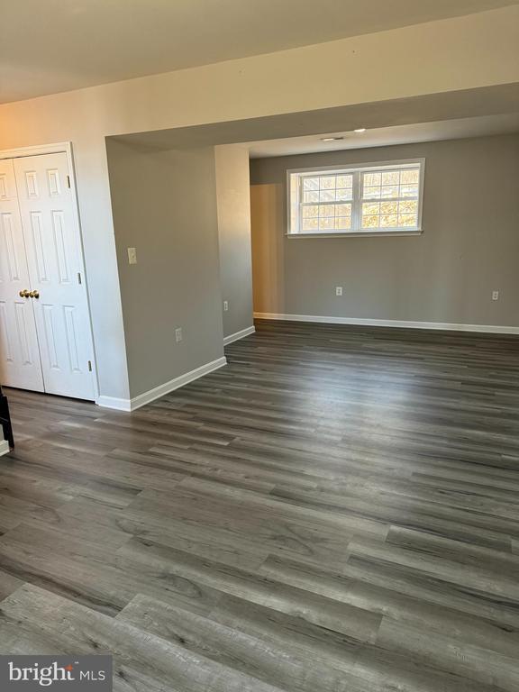 spare room with dark hardwood / wood-style flooring