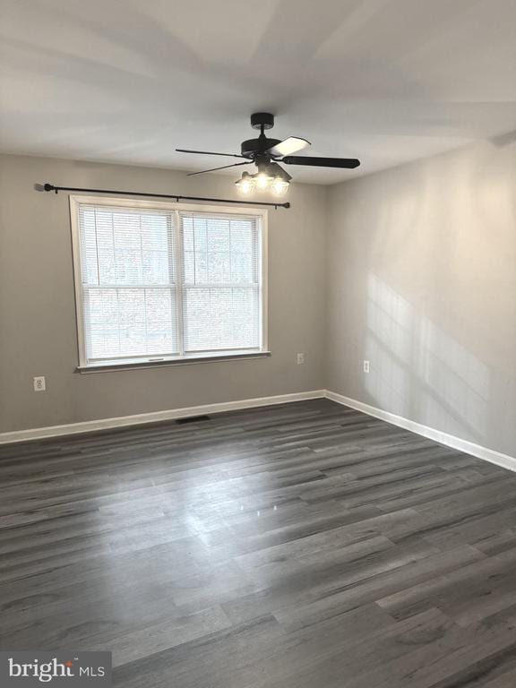 unfurnished room featuring dark hardwood / wood-style flooring and ceiling fan