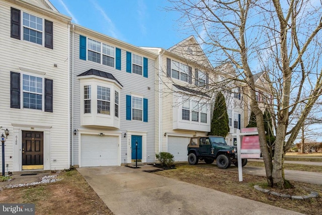 townhome / multi-family property with a garage and concrete driveway