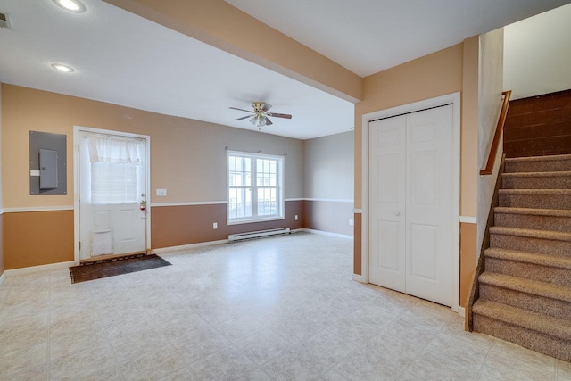 foyer with electric panel, baseboards, ceiling fan, stairs, and a baseboard heating unit