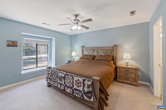 bedroom featuring light carpet, visible vents, and baseboards