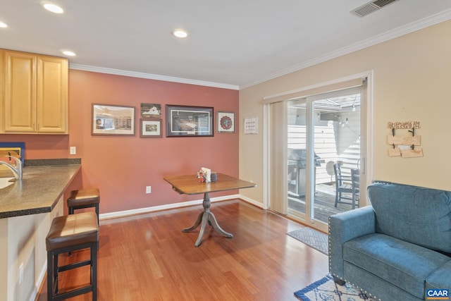 office area featuring ornamental molding, visible vents, baseboards, and wood finished floors