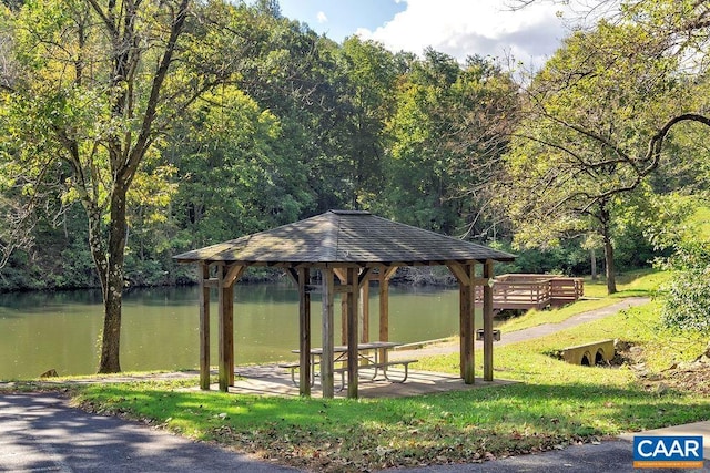 view of community with a gazebo, a forest view, and a water view