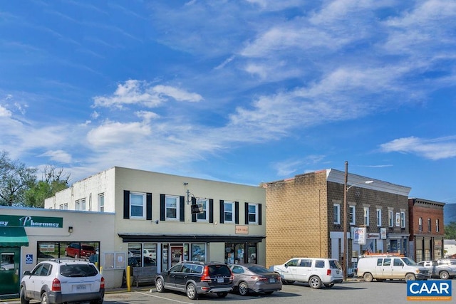 view of building exterior with uncovered parking