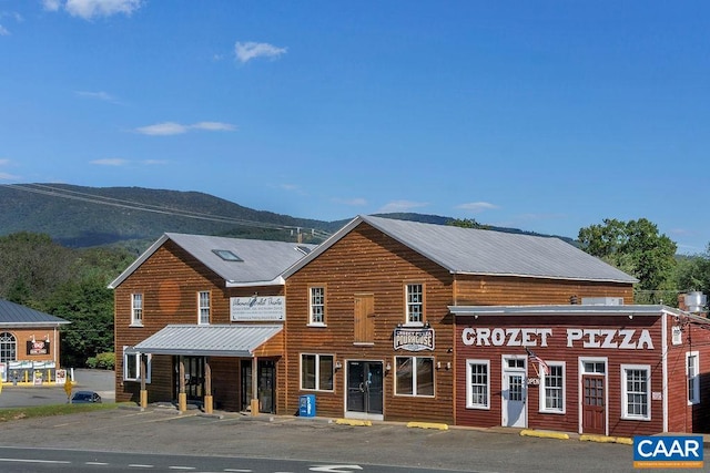 view of front of house featuring metal roof and a mountain view