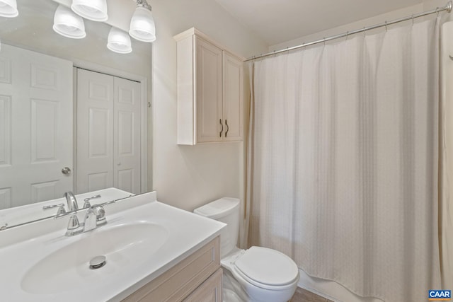 bathroom featuring toilet, a shower with curtain, and vanity