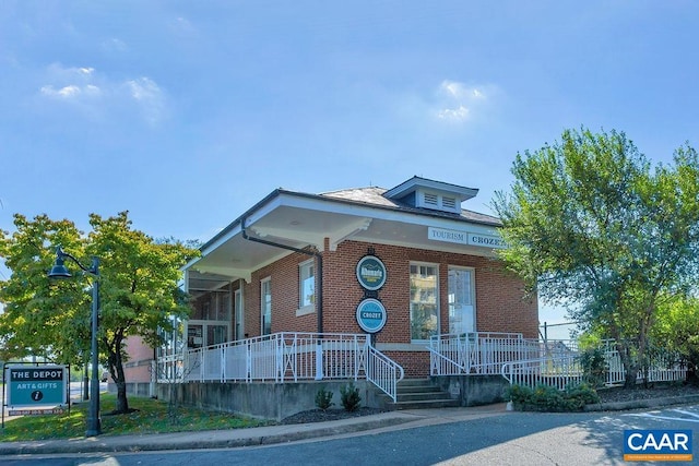 view of front of property featuring a porch and brick siding