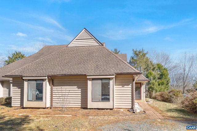 exterior space with roof with shingles