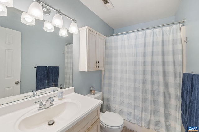 bathroom with toilet, visible vents, and vanity