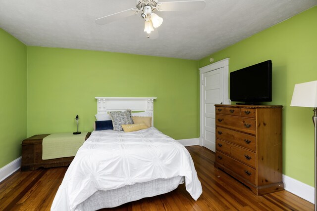 bedroom featuring a ceiling fan, wood finished floors, and baseboards