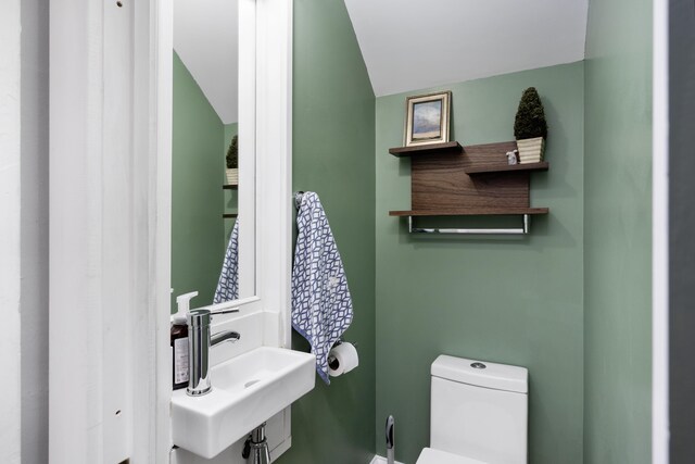 half bath featuring a sink and toilet