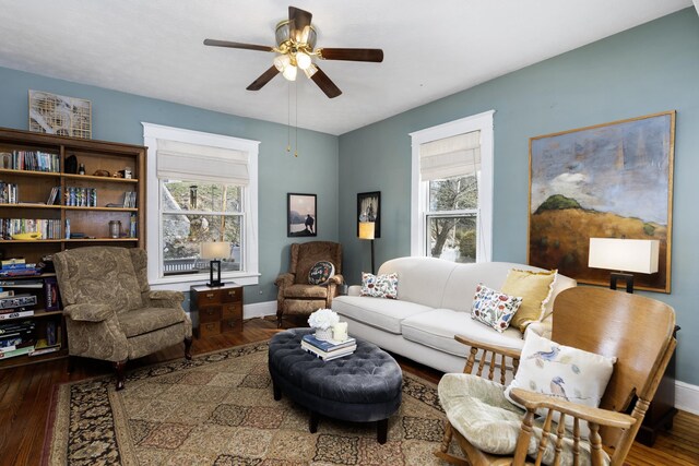 living room with a wealth of natural light, baseboards, and wood finished floors