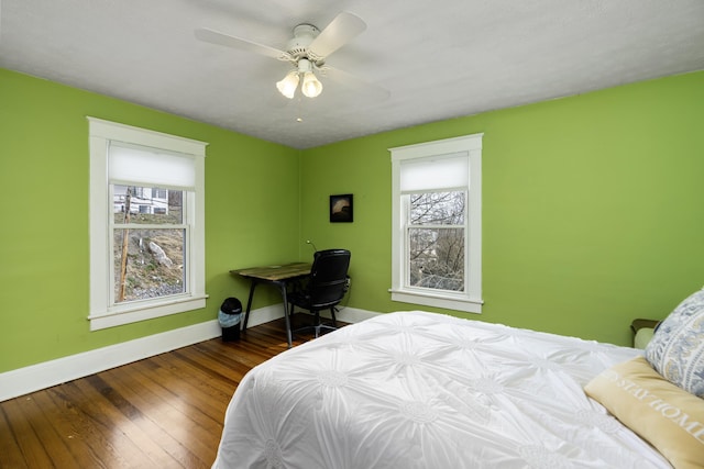 bedroom featuring wood finished floors, baseboards, and ceiling fan