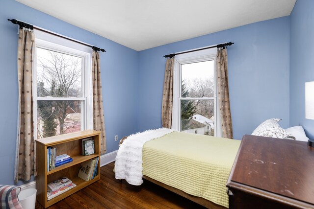 bedroom featuring baseboards and wood finished floors