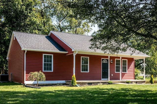 view of front of property featuring central AC unit and a front lawn